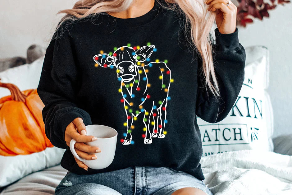 a woman sitting on a bed holding a cup of coffee