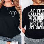 a woman wearing a black shirt that says at the ballpark is where i spend