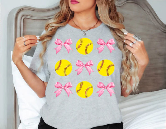 a woman wearing a t - shirt with softballs and bows on it