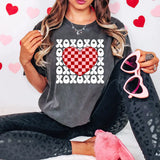 a woman sitting on a bed holding a pair of pink shoes