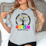 a woman wearing a t - shirt that says autism awareness