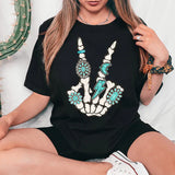 a woman sitting on a bed wearing a black shirt