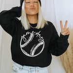 a woman wearing a black baseball sweater and a beanie