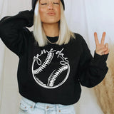 a woman wearing a black baseball sweater and a beanie
