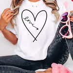 a woman wearing a t - shirt with a heart drawn on it