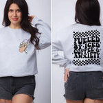 a woman wearing a sweatshirt that says fueled by iced coffee