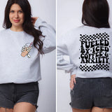 a woman wearing a sweatshirt that says fueled by iced coffee